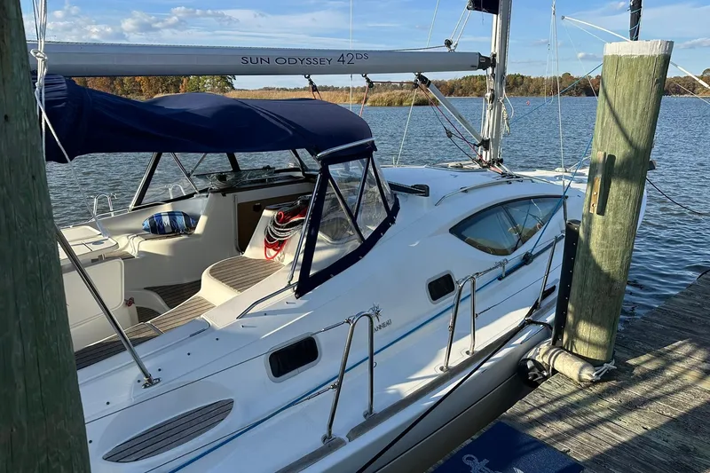 Slide: The Image of 2008 Jeanneau Sun Odyssey 42 DS sailboat docked by a serene lake. - 3