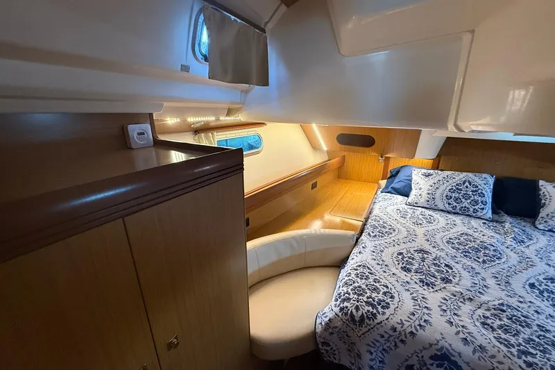 Slide: The Image of Interior of 2008 Jeanneau Sun Odyssey 42 DS with cozy bed and wooden cabinetry. - 32