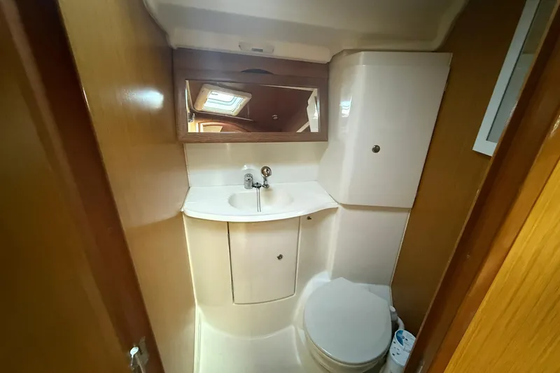 Slide: The Image of 2008 Jeanneau Sun Odyssey 42 DS yacht bathroom with sink, mirror, and toilet. - 33