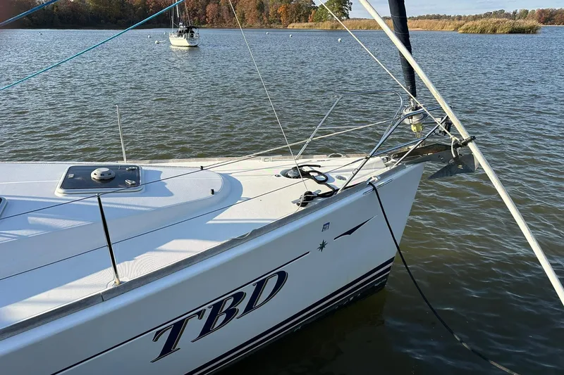 Slide: The Image of 2008 Jeanneau Sun Odyssey 42 DS sailboat docked on a calm lake. - 4