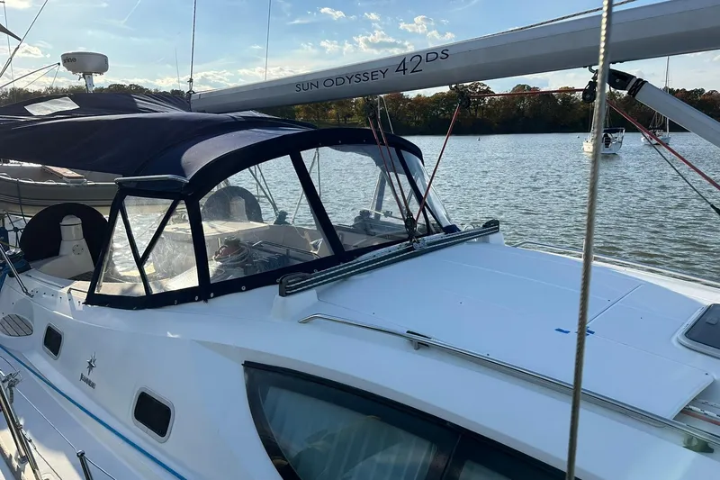 Slide: The Image of 2008 Jeanneau Sun Odyssey 42 DS sailboat docked on a calm lake. - 5