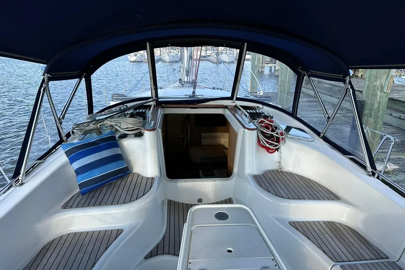 Slide: The Image of Cockpit of 2008 Jeanneau Sun Odyssey 42 DS sailboat with striped cushion and ropes. - 6