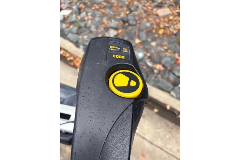 Slide: The Image of Close-up of a 2021 Tracker Pro Team 190 TX boat control panel with yellow button. - 11