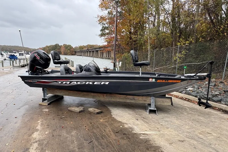 Slide: The Image of 2021 Tracker Pro Team 190 TX boat on a dock, surrounded by autumn trees. - 3