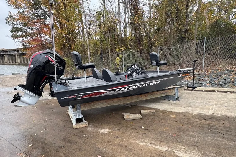 Slide: The Image of 2021 Tracker Pro Team 190 TX boat on a dock, surrounded by autumn trees. - 4
