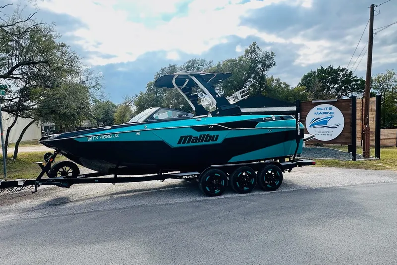 The Image of 2021 Malibu M240 boat on trailer at Elite Marine dealership. - 0