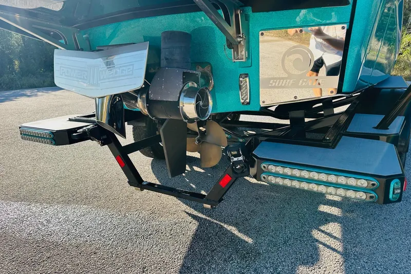 Slide: The Image of 2021 Malibu M240 boat with Power Wedge III and Surf Gate features. - 12