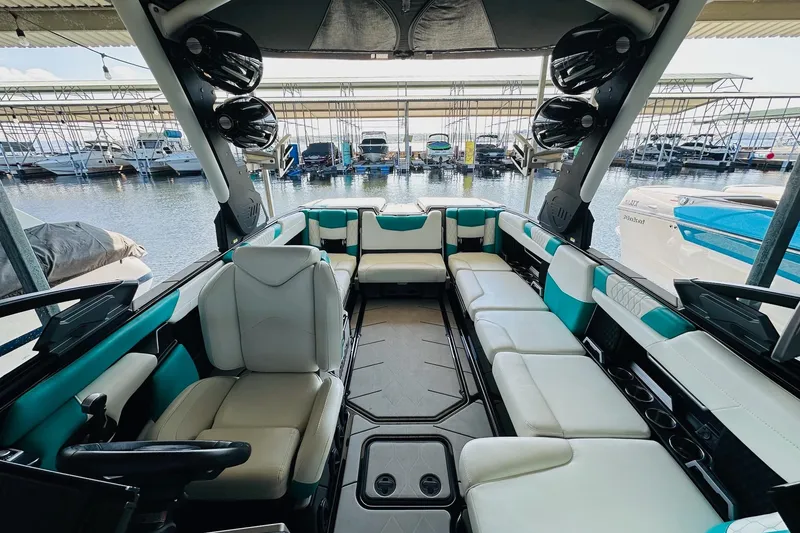 Slide: The Image of Interior of a 2021 Malibu M240 boat with spacious seating and modern design. - 20