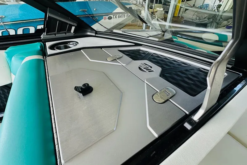 Slide: The Image of 2021 Malibu M240 boat interior with sleek design and teal accents. - 27