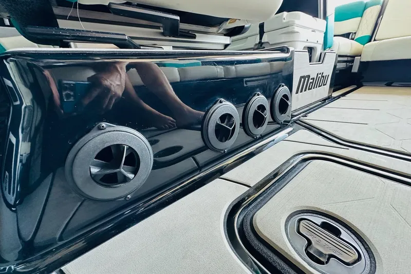 Slide: The Image of 2021 Malibu M240 boat interior with sleek design and modern speaker system. - 28