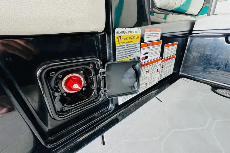 Slide: The Image of 2021 Malibu M240 interior with safety labels and red switch, maximum capacity details visible. - 36