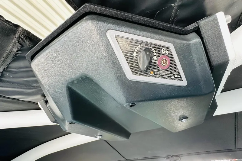 Slide: The Image of 2021 Malibu M240 boat control panel with adjustment knob and power button. - 38