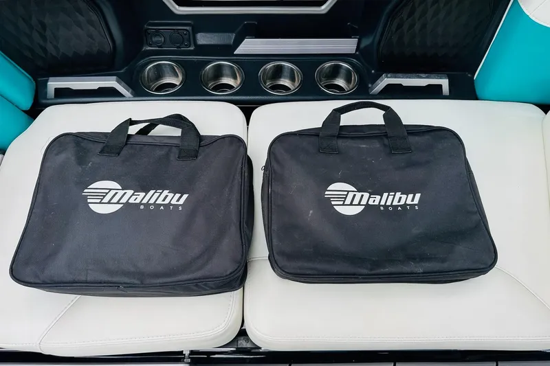 Slide: The Image of Two black Malibu Boats bags on white seats in a 2021 Malibu M240. - 39