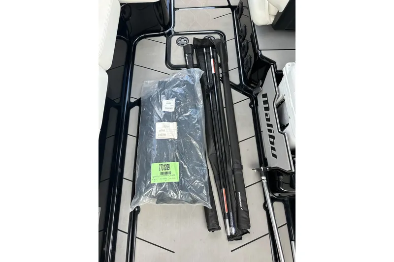 Slide: The Image of 2021 Malibu M240 boat interior with packaged accessories and equipment. - 40