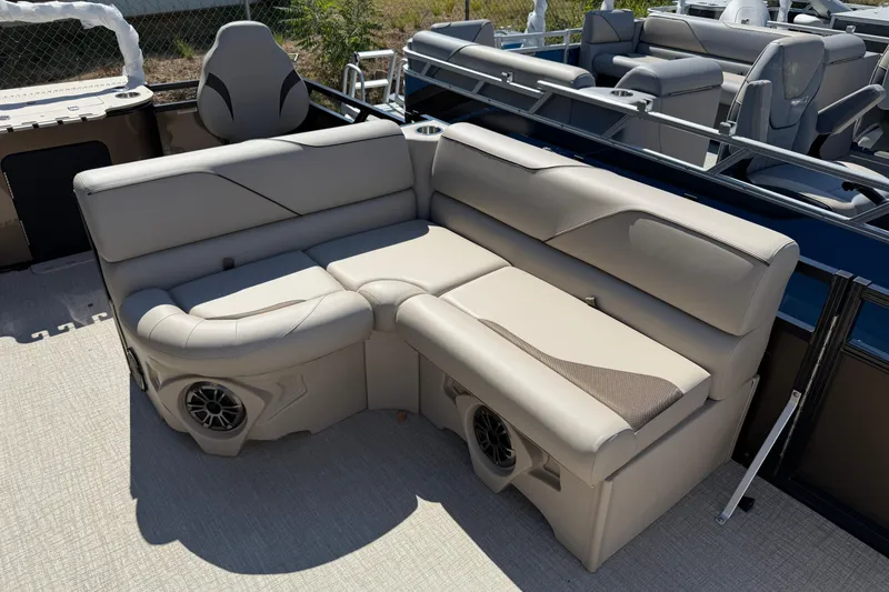 Slide: The Image of 2026 Tahoe Pontoon Sport 85 Rear Fish with beige seating and integrated speakers. - 8