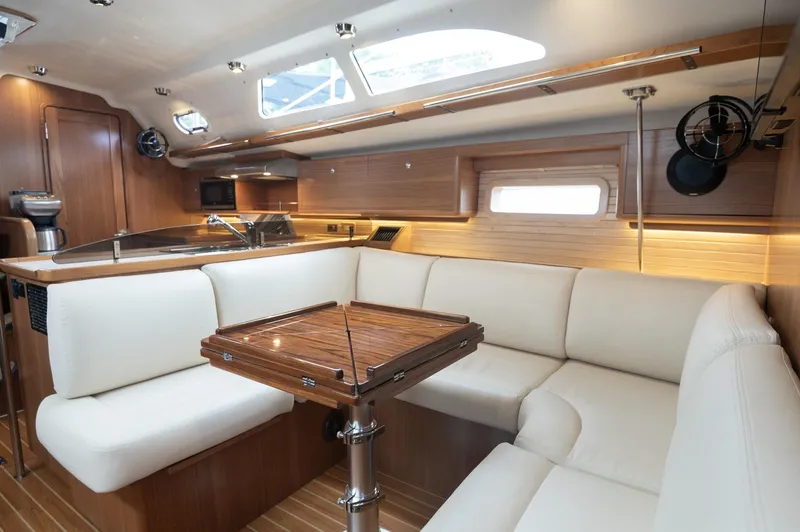 The Image of 2024 Catalina 445 yacht interior with elegant wood finish and plush white seating. - 0