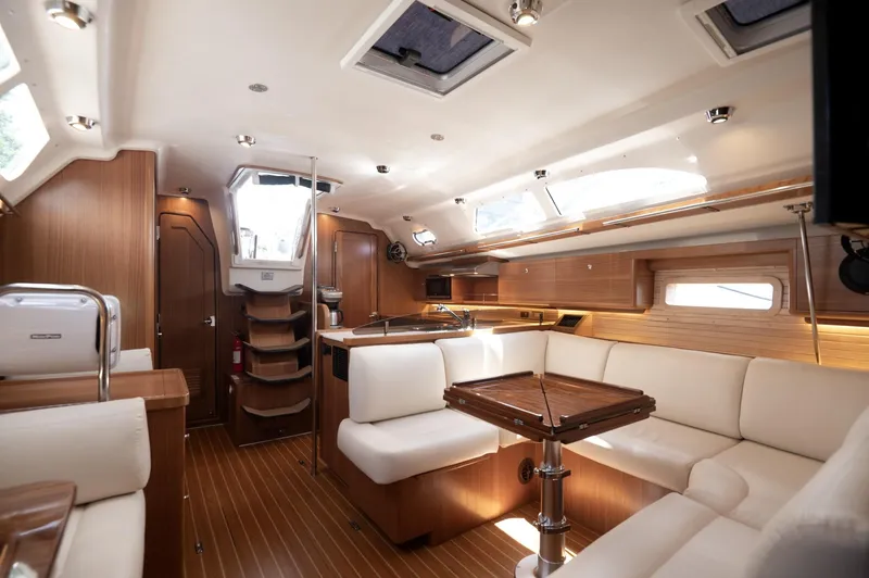Slide: The Image of Luxurious interior of 2024 Catalina 445 yacht with elegant wood finish and plush seating. - 11