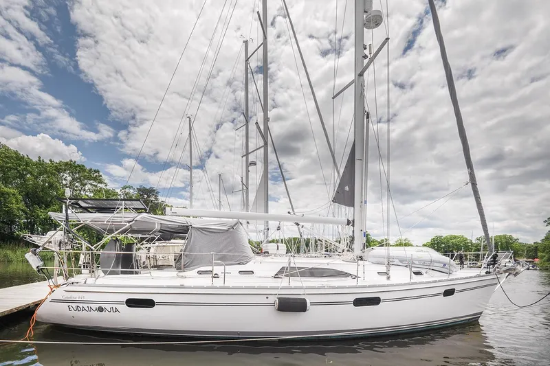 Slide: The Image of 2024 Catalina 445 sailboat docked under cloudy sky, showcasing sleek design and modern features. - 13