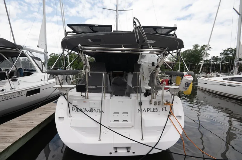 Slide: The Image of 2024 Catalina 445 sailboat docked, rear view, with equipment and ropes visible. - 14