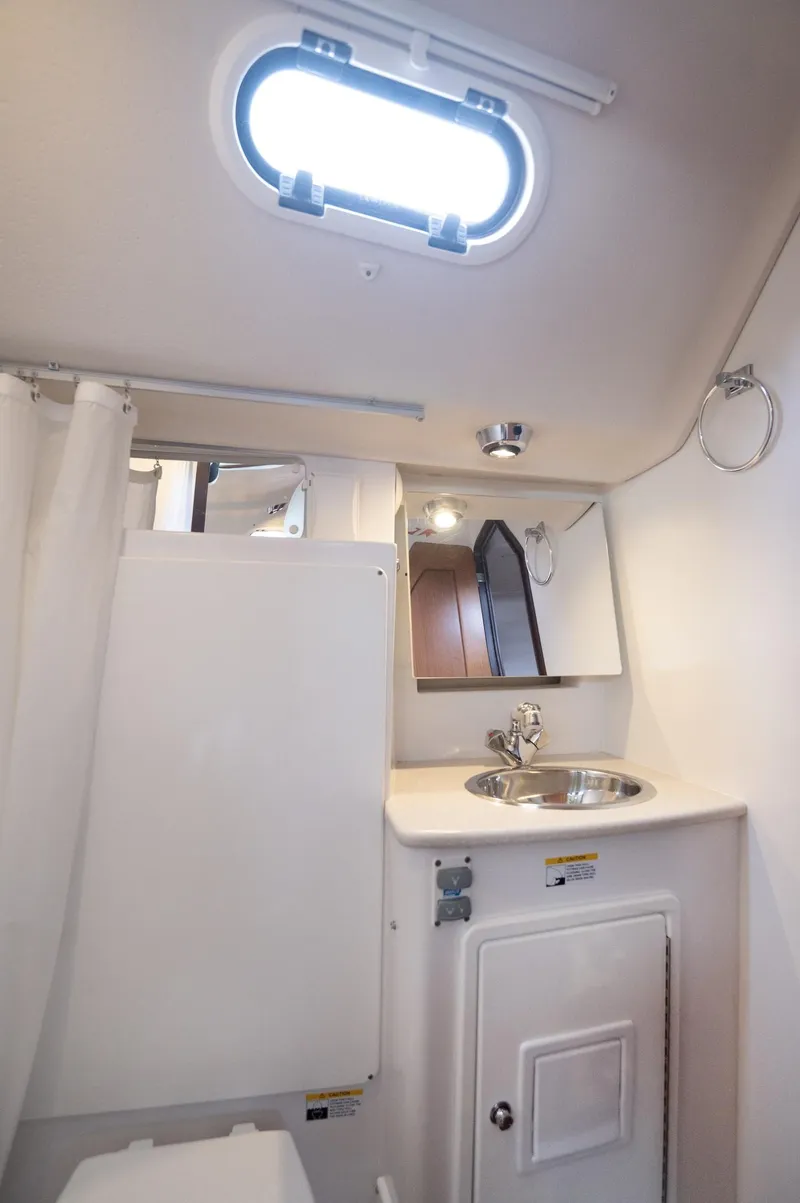 Slide: The Image of 2024 Catalina 445 yacht bathroom with sink, mirror, and porthole window. - 16