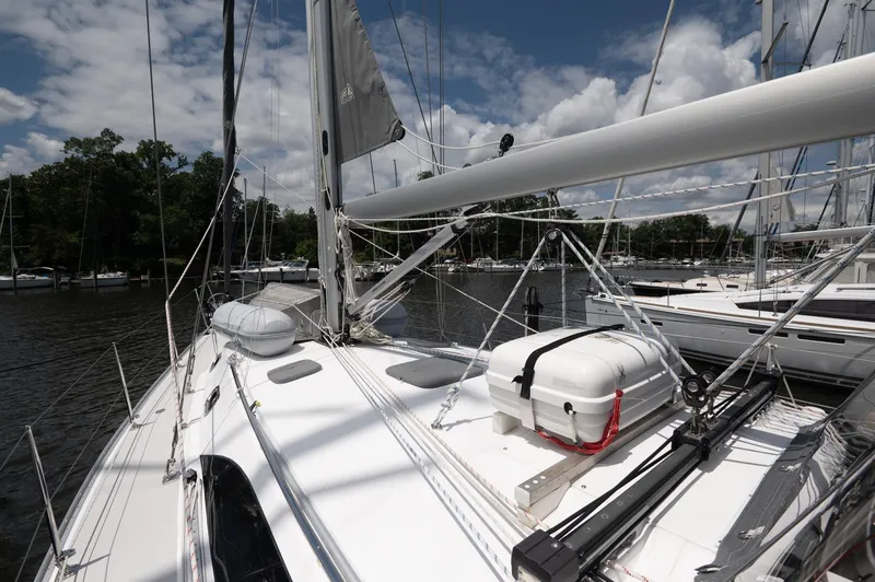 Slide: The Image of 2024 Catalina 445 sailboat docked, showcasing deck and rigging under a partly cloudy sky. - 26