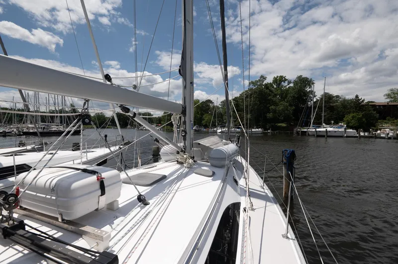 Slide: The Image of 2024 Catalina 445 sailboat docked in a marina under a partly cloudy sky. - 29