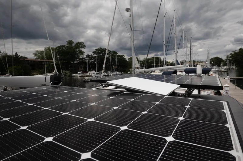 Slide: The Image of Solar panels on a 2024 Catalina 445 sailboat under cloudy skies at a marina. - 30