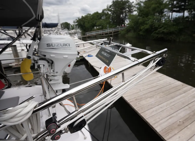 Slide: The Image of 2024 Catalina 445 sailboat with Suzuki outboard motor docked at marina. - 31