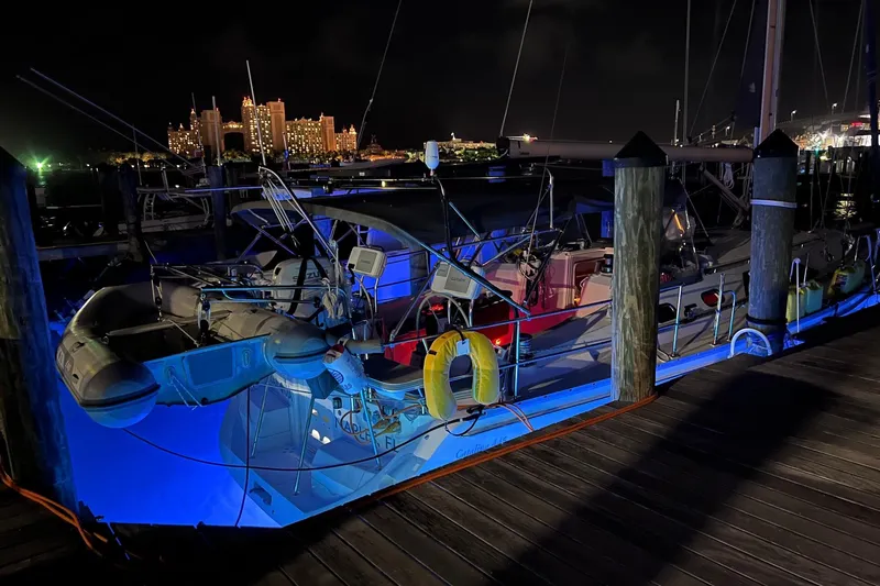 Slide: The Image of 2024 Catalina 445 sailboat docked at night with city lights in the background. - 34