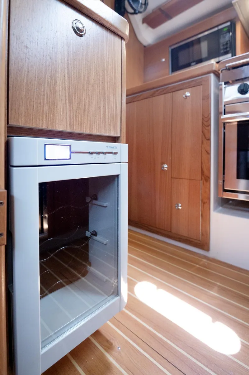 Slide: The Image of 2024 Catalina 445 yacht interior with wooden cabinetry and modern appliances. - 6