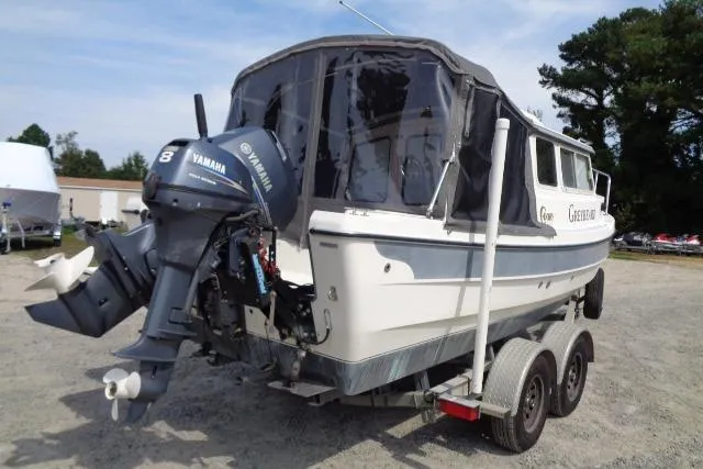 Slide: The Image of 2004 C-Dory 22 Cruiser with Yamaha outboard motor on trailer, parked outdoors. - 11