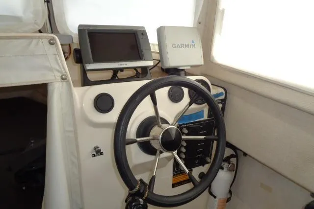 Slide: The Image of Steering wheel and Garmin GPS on 2004 C-Dory 22 Cruiser boat dashboard. - 13