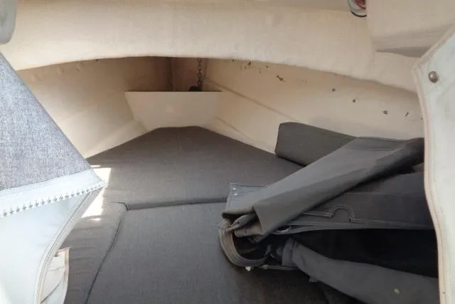Slide: The Image of 2004 C-Dory 22 Cruiser cabin interior with folded seats and gray upholstery. - 14