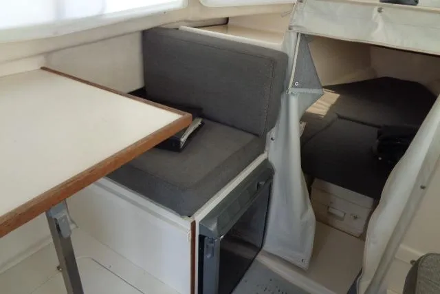Slide: The Image of Interior of 2004 C-Dory 22 Cruiser, featuring seating and compact cabin space. - 15