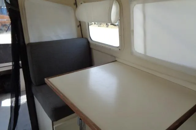 Slide: The Image of 2004 C-Dory 22 Cruiser interior with dining table and cushioned seating. - 17