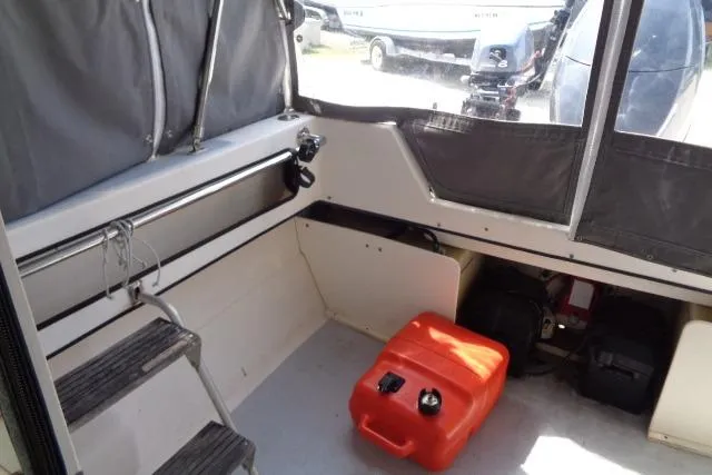 Slide: The Image of 2004 C-Dory 22 Cruiser interior with storage, seating, and equipment. - 20