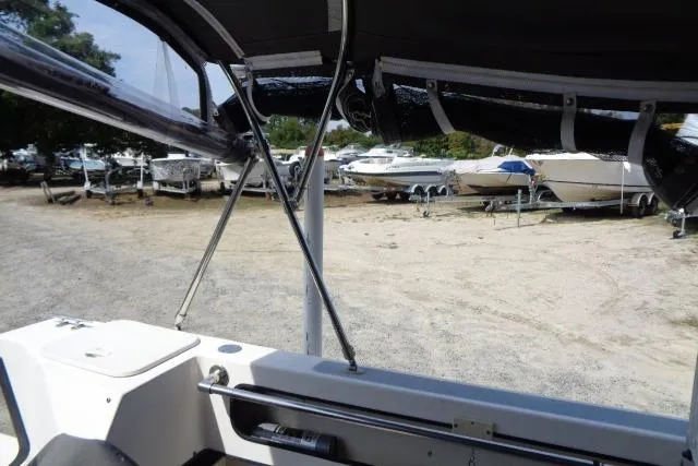 Slide: The Image of 2004 C-Dory 22 Cruiser interior view with boats in the background. - 25