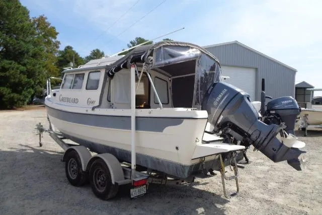 Slide: The Image of 2004 C-Dory 22 Cruiser boat on trailer with Yamaha outboard motor, parked outdoors. - 26