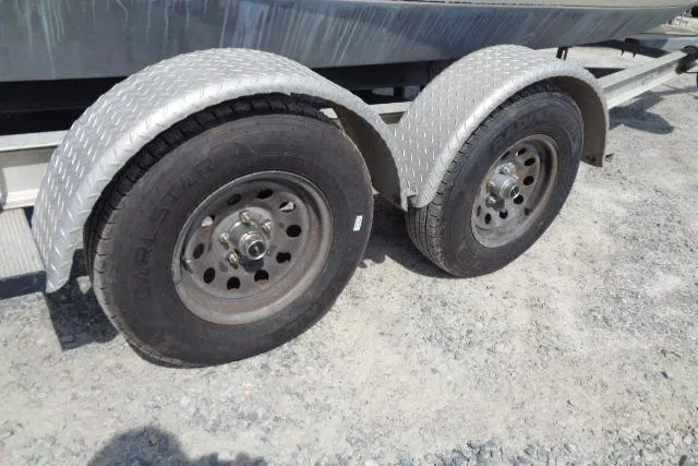 Slide: The Image of Trailer wheels for 2004 C-Dory 22 Cruiser on gravel surface. - 27
