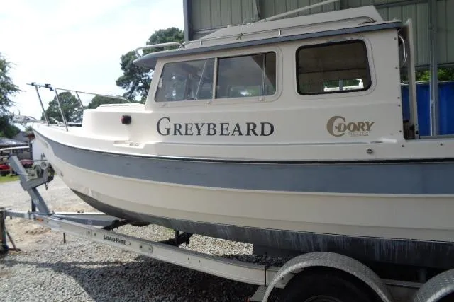 Slide: The Image of 2004 C-Dory 22 Cruiser boat named "Greybeard" on a trailer, side view. - 29