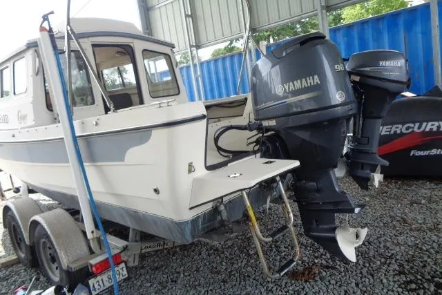 Slide: The Image of 2004 C-Dory 22 Cruiser with Yamaha outboard motor on trailer in storage. - 30