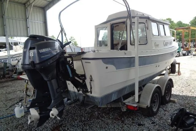 Slide: The Image of 2004 C-Dory 22 Cruiser with Yamaha outboard motor on a trailer in a storage area. - 31