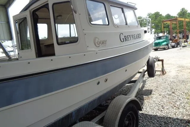 Slide: The Image of 2004 C-Dory 22 Cruiser boat on trailer, side view, outdoors. - 33