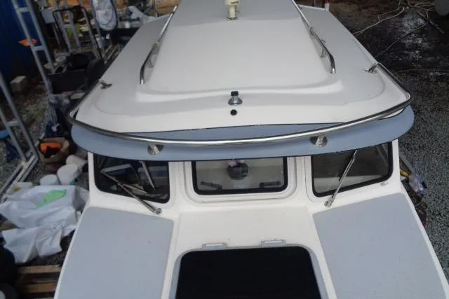 Slide: The Image of 2004 C-Dory 22 Cruiser boat, top view, showcasing cabin roof and windows. - 35