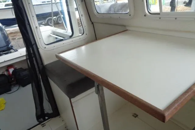 Slide: The Image of 2004 C-Dory 22 Cruiser interior with table and seating area. - 41