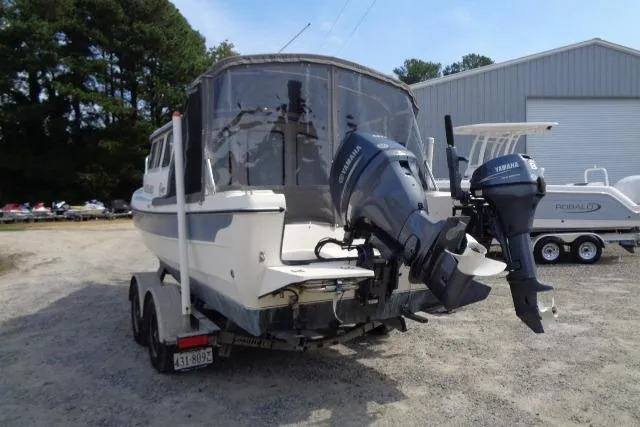 Slide: The Image of 2004 C-Dory 22 Cruiser with dual Yamaha outboard motors on a trailer. - 9