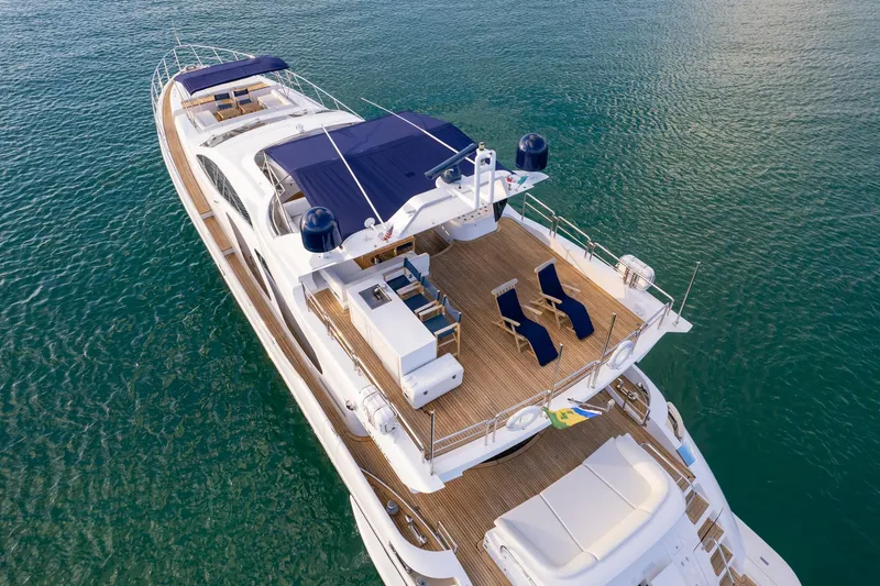 Slide: The Image of Luxurious 2006 Azimut 98 Leonardo yacht on serene water, featuring spacious deck and seating. - 15