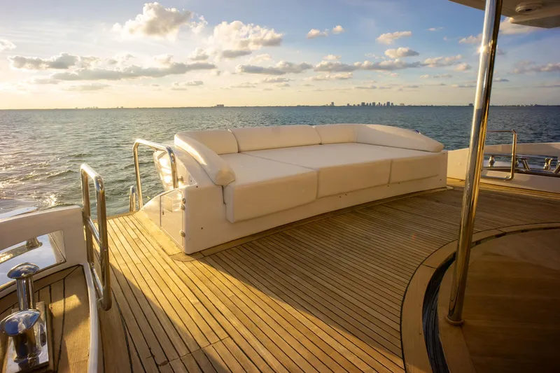 Slide: The Image of Luxurious 2006 Azimut 98 Leonardo yacht deck with white seating, overlooking serene ocean view. - 30