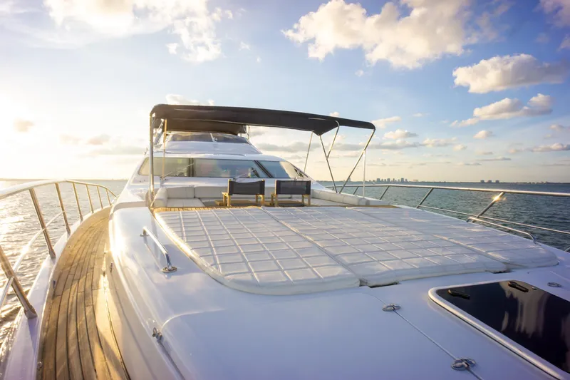 Slide: The Image of Luxurious 2006 Azimut 98 Leonardo yacht deck with sunbathing area, ocean view, and clear sky. - 35