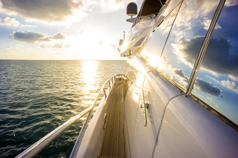 Slide: The Image of Azimut 98 Leonardo yacht cruising at sunset, reflecting sunlight on calm ocean waters. - 41